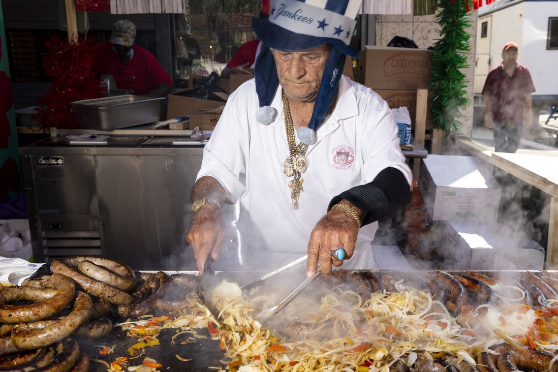 Vincenzo gets the sausages ready at his booth. He has been working the festival for over 50 years. The Feast of San Gennaro in the Little Italy neighborhood of Manhattan. Saturday 09 17 2022  New York, NY.  © Aristide Economopoulos for WNYC